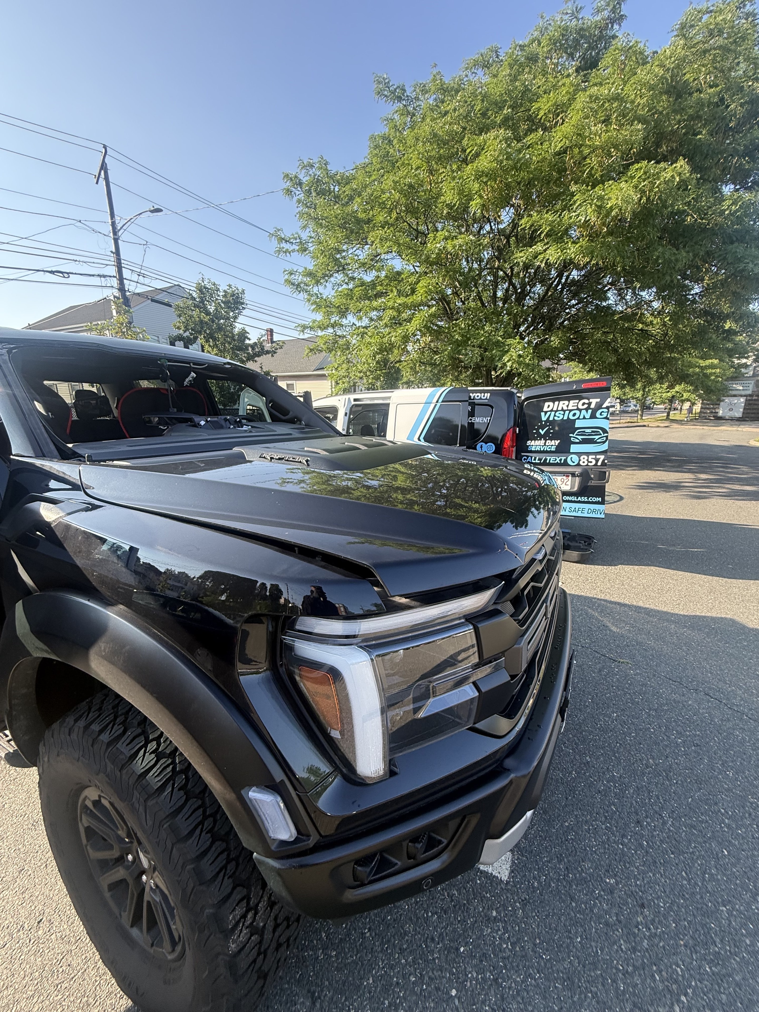 Direct Auto Vision Glass service van on location with a Ford Raptor customer vehicle